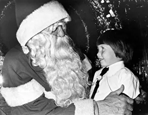 A young girl meeting Father Christmas in the grotto at Debenham s, Teesside