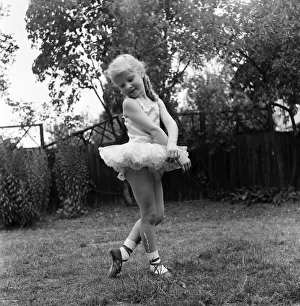 00010 Prints: Young girl Penny Brown practising her Ballet dancing wearing a tutu in the back garden
