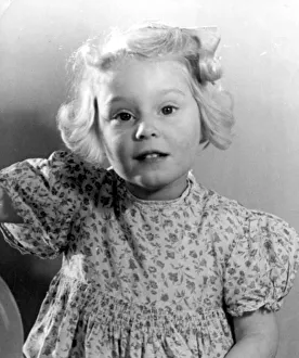 Young girl wearing a flowery dress Circa 1945 P044423