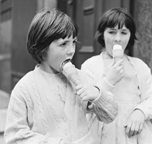 Cone Prints: Two young girls enjoy eating ice creams 9th April 1962