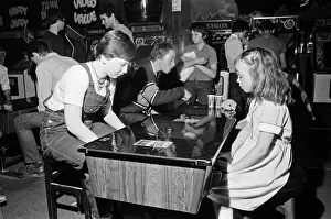 Games Prints: Young holidaymakers play the video machines at the James Corrigan seafront amusement