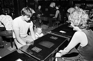 Young holidaymakers play the video machines at the James Corrigan seafront amusement