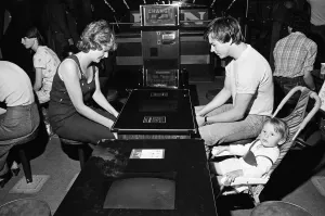 01262 Prints: Young holidaymakers play the video machines at the James Corrigan seafront amusement
