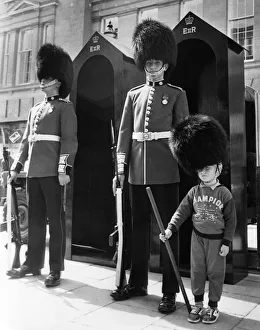 Core07 Prints: This young lad has volunteered to to help out the Coldstream Guards when they set up a