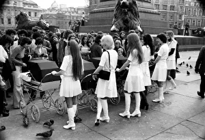 Six young ladies pushing prams on a sunny day in Trafalgar Square