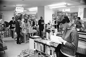 Young lady reading a text book in the Technical book department at Foyles bookshop in