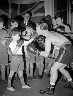 This young man is learning how to fight from a professional boxer. 1949