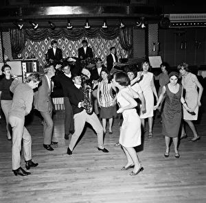 Young mods with hands clasped behind their backs dance The Blues to the music of the Dave