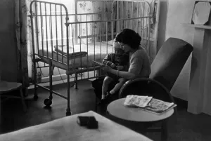 00097 Prints: Young patient at a hospital after having an operation for gland trouble