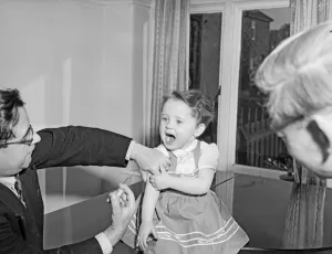 Injection Prints: A young patient looks on with trepidation whilst having her polio vaccination
