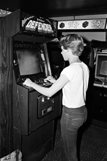 01262 Prints: Young people playing video games in an amusement arcade in London. 13th July 1983