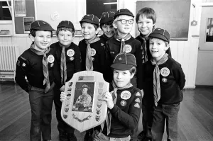 Proud Prints: Young Timothy Hutton displays a Holme Valley cub scout swimming trophy watched by other