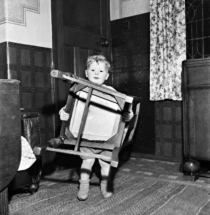 00026 Prints: Young toddler boyholding a wooden chair December 1952 C6391-001