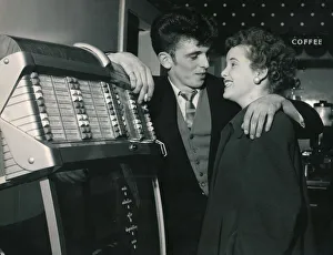 Interiors Prints: A young trendy couple select their song on the Juke box as they prepare to get married