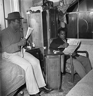 Immigration Prints: Young West Indian men in Brixton looking through the small ads in the local newspapers
