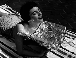 Sun Bathing Prints: A young woman catching some rays whilst on holidays June 1954