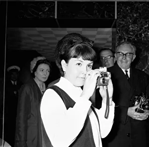 A young woman takes a photograph of Prime Minister Harold Wilson (1916 - 1995