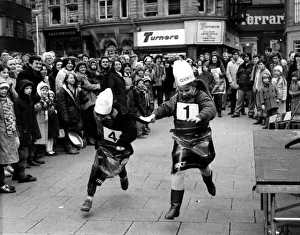 Two youngsters battle it out in the Shrove Tuesday Pancake race at Grey