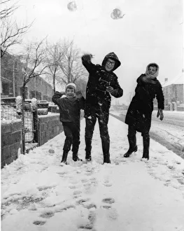 00173 Prints: Three youngsters at Llanrumney, Cardiff throw snowballs at the cameraman during