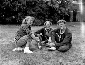 Youth Club. Three teenage friends enjoy sitting outdoors in the summer