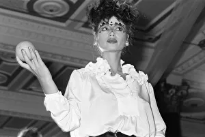 00862 Prints: Zandra Rhodes Fashion Show, Olympia, London, October 1980. Model holding fruit, orange